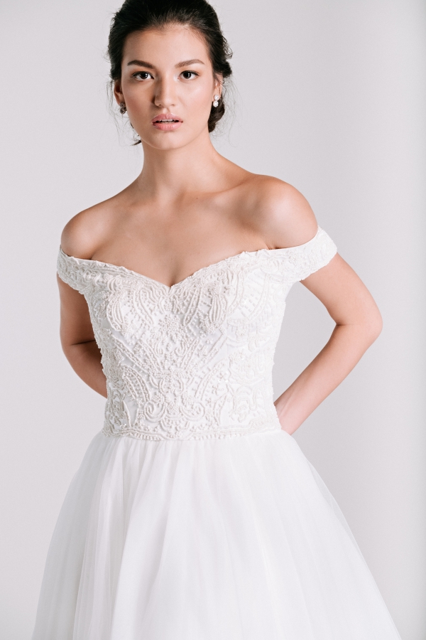 off shoulder beaded wedding dress by Ivory & White Bridal Store