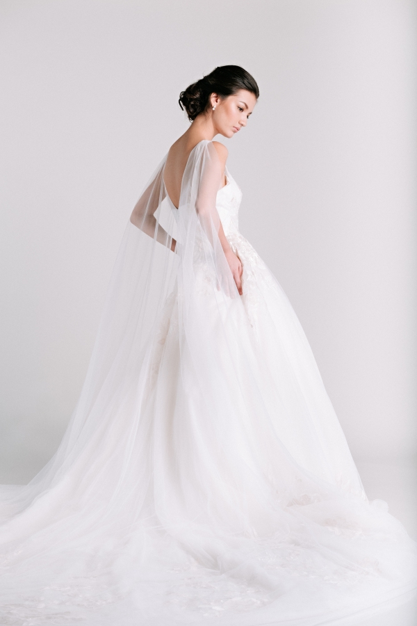 wedding dress with cape from Ivory & White Bridal Store